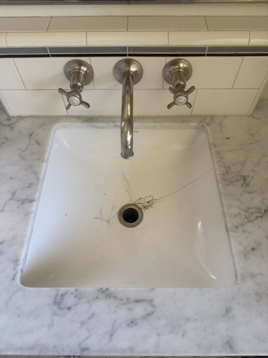Cracked ceramic sink leaking water